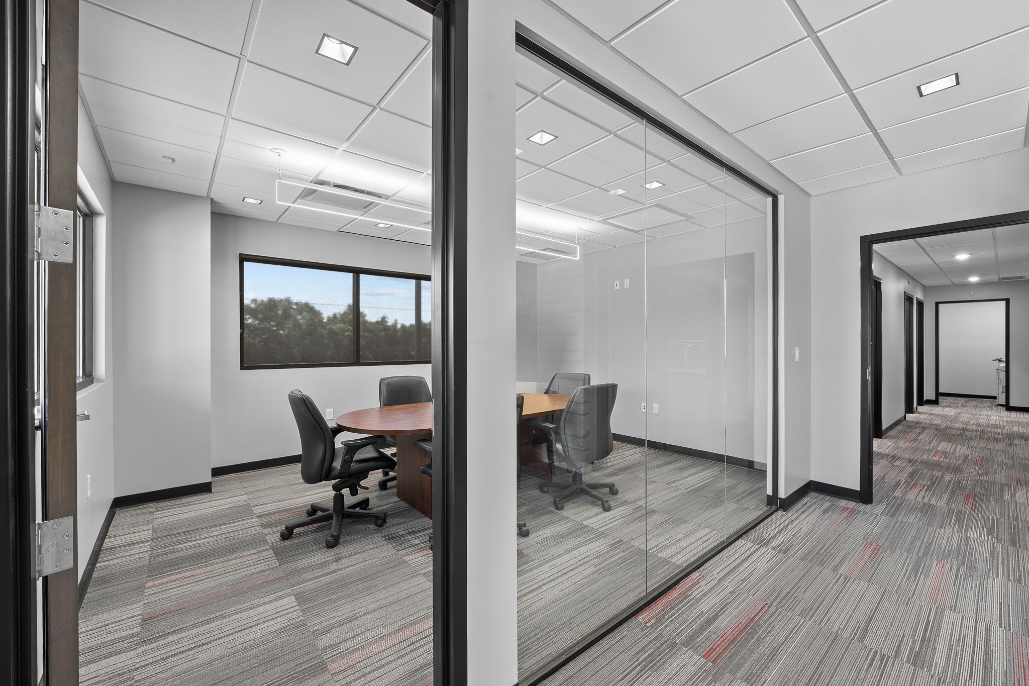 Glass-walled executive conference room with Hill Country views